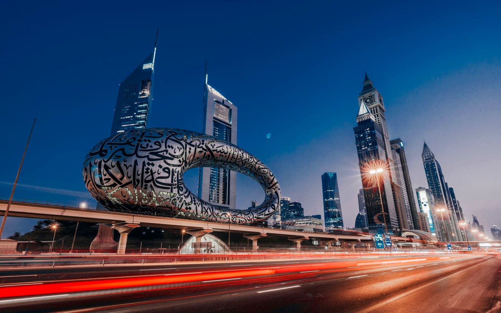 Dubai's Museum of the Future at blue hour, light trails on Sheikh Zayed Road below the Emirates Towers